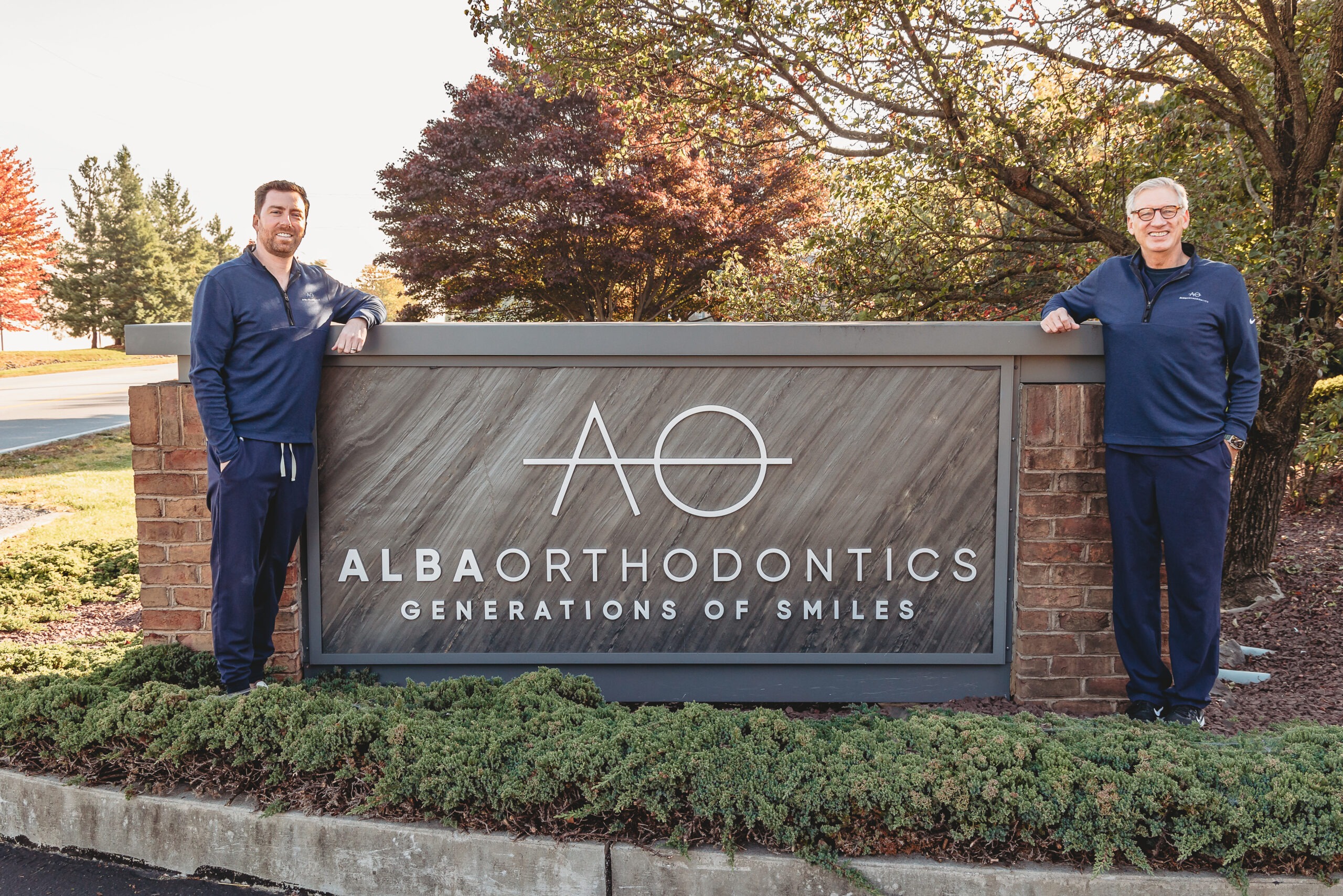 Both doctors near the office building sign
