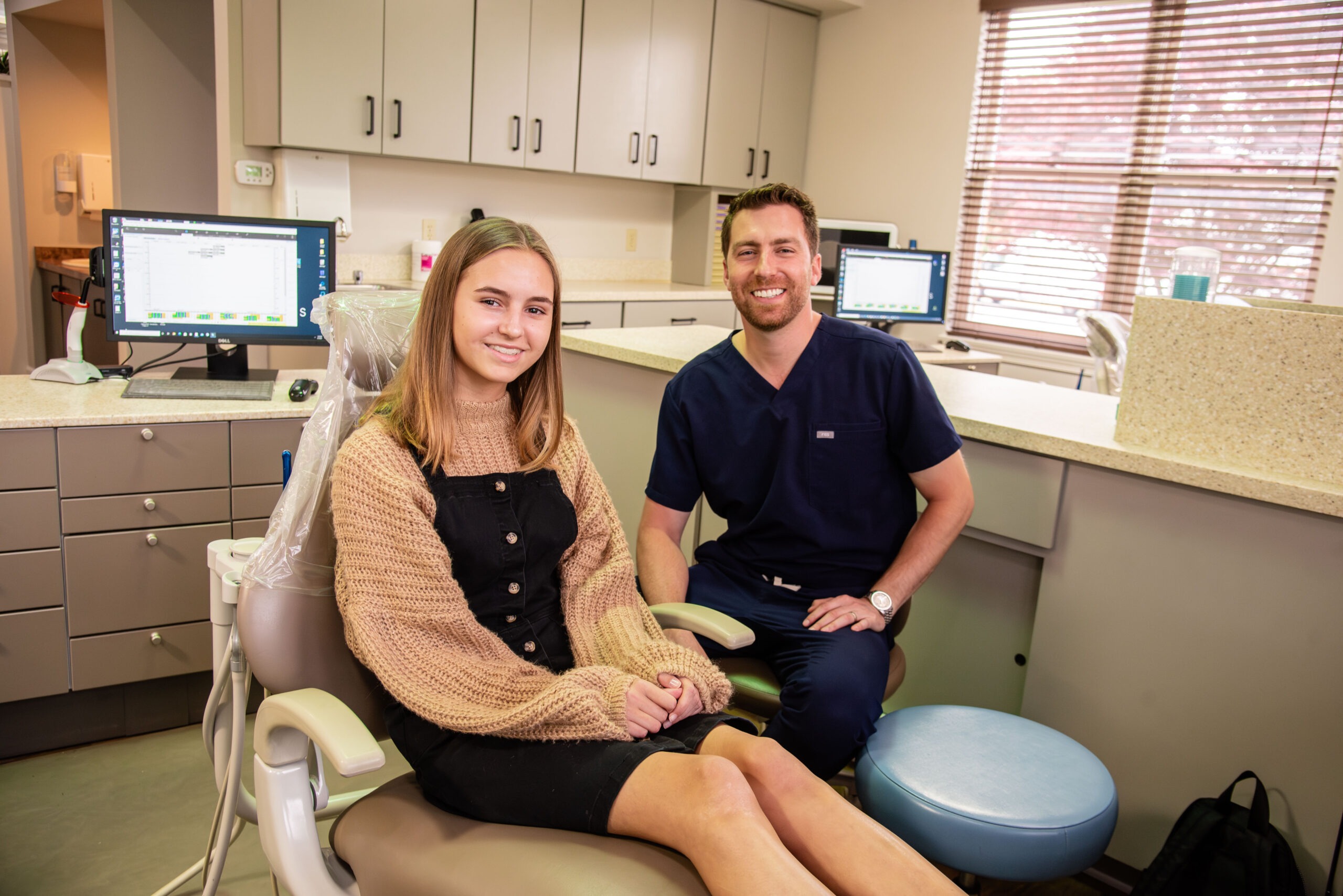 Teen female patient and doctor smiling