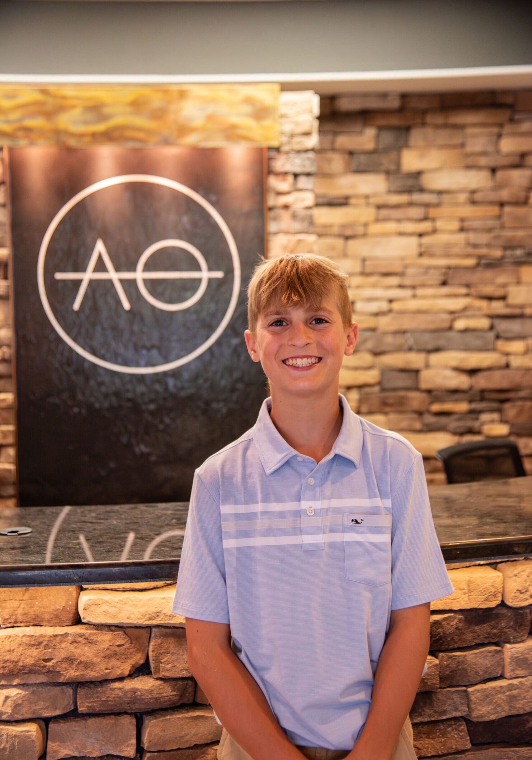 Teen male smiling in office