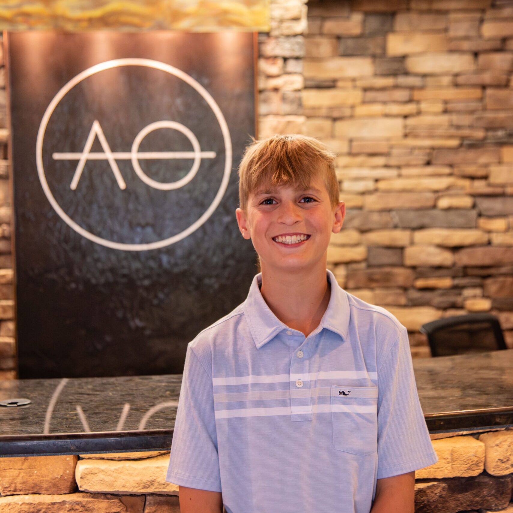 Teen male smiling in office