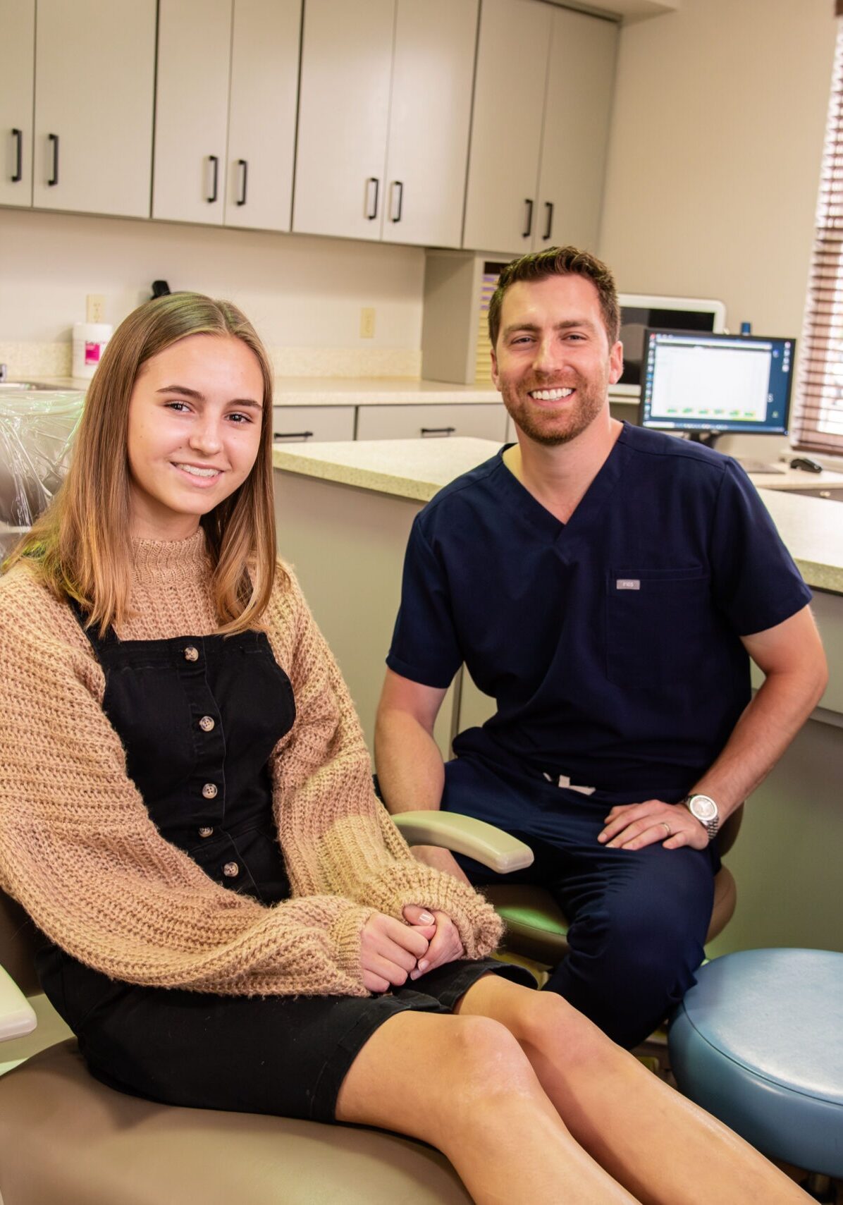 Doctor smiling with female teen patient