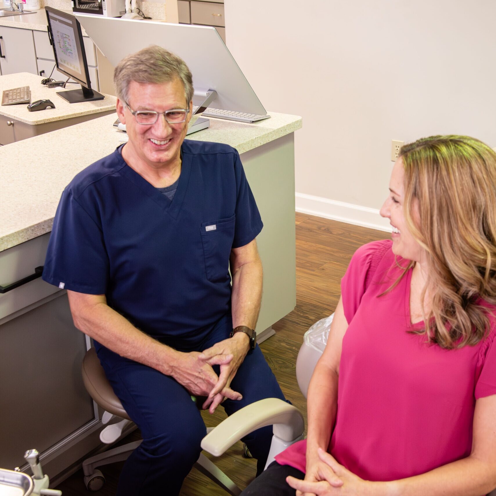 Doctor smiling with adult female patient